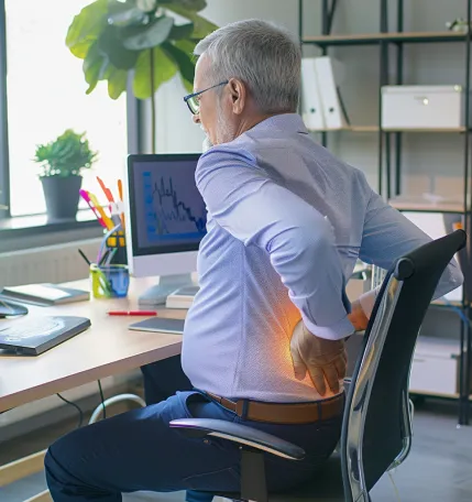 Man sitting at desk with back pain.